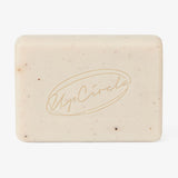 UpCircle Fennel + Cardamom Chai Cleansing Bar resting on a textured cream ceramic soap dish with minimalist branding.
