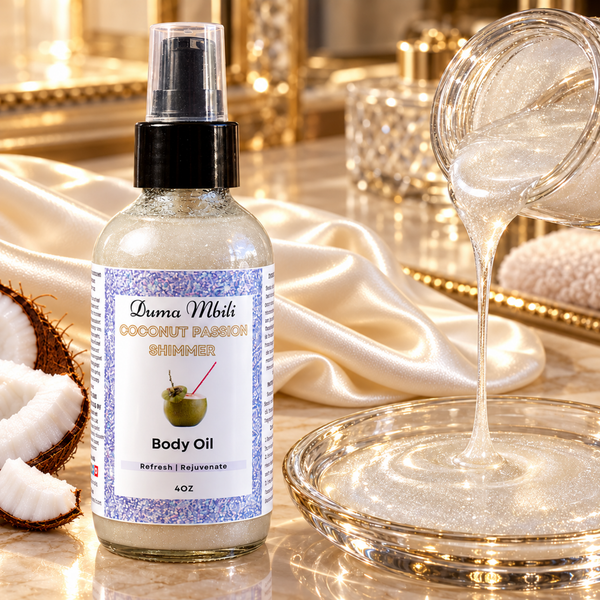 Adorn Collective Coconut Passion Shimmer Body Oil in a sleek glass bottle resting on a textured travertine plinth.