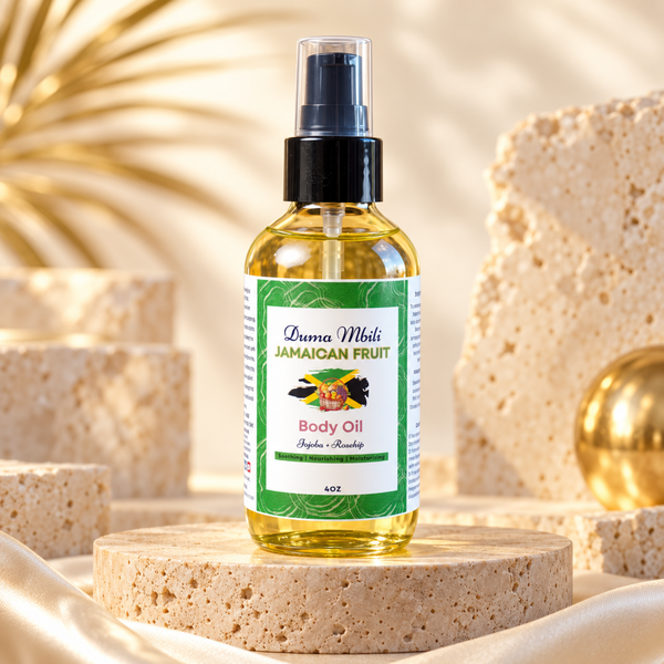 Adorn Collective Jamaican Fruit Body Oil in a sleek amber glass bottle, displayed elegantly on a textured travertine plinth.