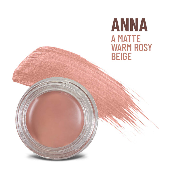 Mommy Makeup Anna Any Wear Creme in a sleek, minimalist compact resting on a textured travertine surface.
