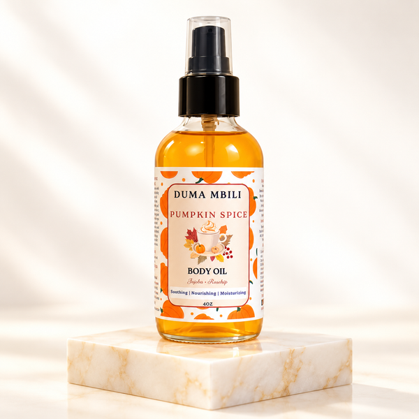 Adorn Collective Pumpkin Spice Body Oil in an amber glass apothecary bottle resting on a textured travertine plinth.