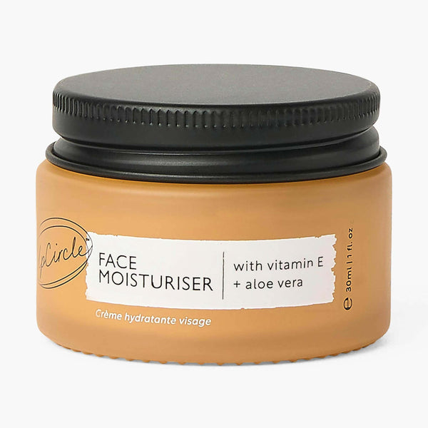 UpCircle Face Moisturizer with Vitamin E travel-size tube resting on a textured cream background.