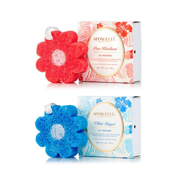 Spongellé Pua Kenikeni & White Ginger body buffers arranged on a textured travertine surface.