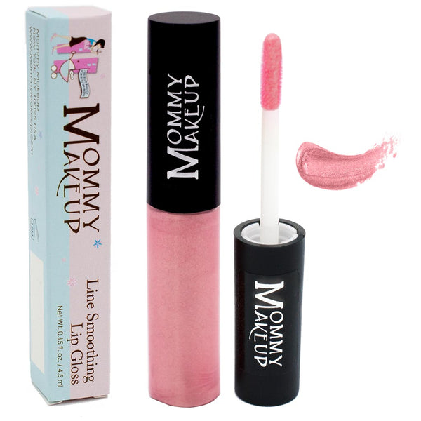Mommy Makeup Line Smoothing Lip Gloss in Pinkalicious inside a sleek clear tube resting on a textured travertine surface.