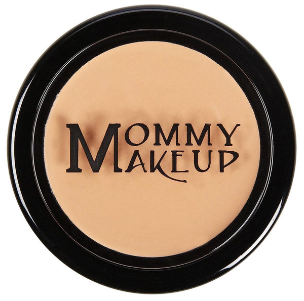 Mommy Makeup RESTED concealer compact in sleek silver packaging set against a textured oatmeal linen background.