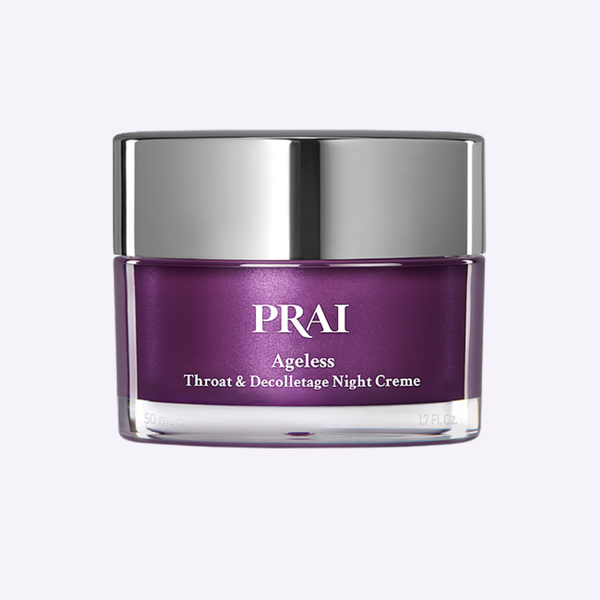 PRAI Beauty Ageless Throat & Decolletage Night Creme in a signature gold and cream jar on a natural travertine plinth.