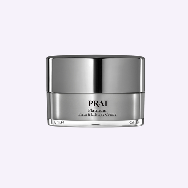 PRAI Beauty Platinum Firm & Lift Eye Creme in a sleek silver-toned luxury jar set against a minimalist neutral backdrop.