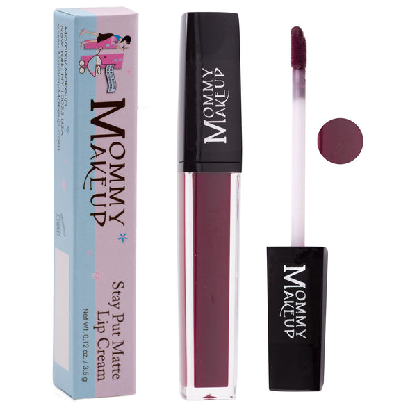 Mommy Makeup Madonna Stay Put Matte Lip Cream in a sleek minimalist tube, displayed on a textured travertine surface.