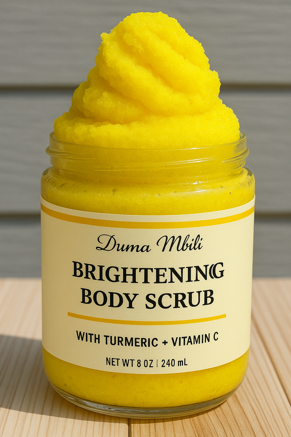 Adorn Collective Turmeric Body Scrub by Duma Mbili LLC presented in a minimalist frosted glass jar on a stone plinth.