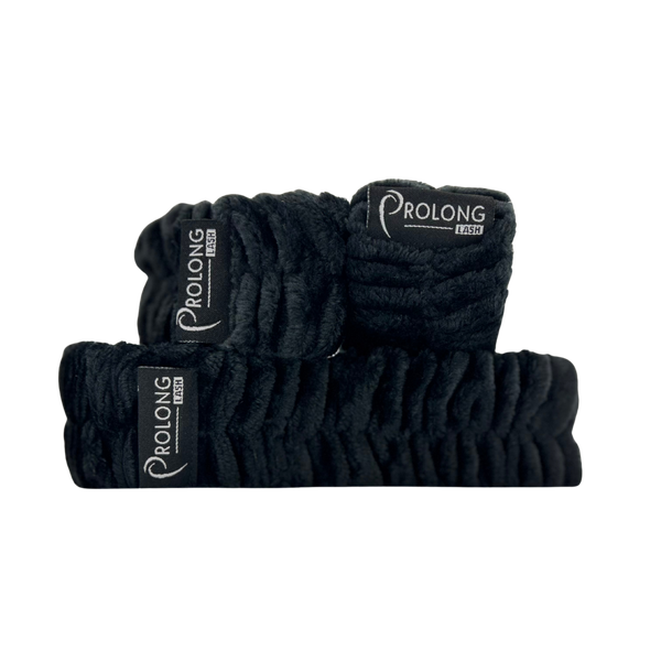 Prolong Lash US cleansing headband and wrist towel set displayed on a textured oatmeal raw silk fabric surface.