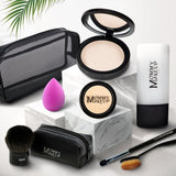 Mommy Makeup All About the Base set featuring a foundation and concealer in sleek, minimalist packaging on stone.