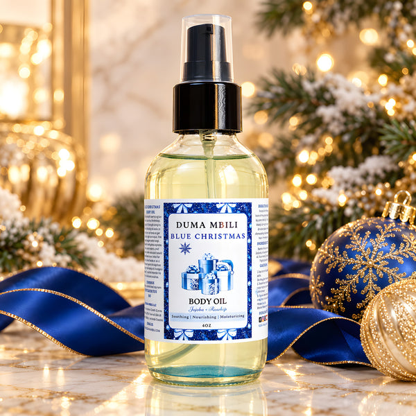 Duma Mbili Blue Christmas Body Oil in a sleek glass bottle resting on a textured travertine surface.