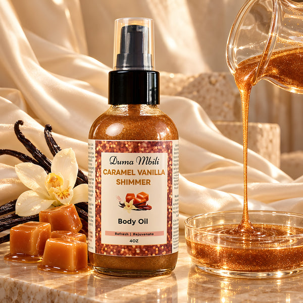 Adorn Collective Caramel Vanilla Shimmer Body Oil in a sleek glass bottle resting on a textured travertine plinth.