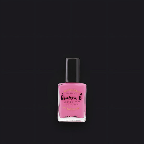 Lauren B. Beauty Clueless in 90210 vegan nail polish in a minimalist glass bottle set on a textured travertine plinth.