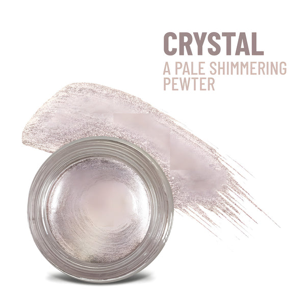 Mommy Makeup Crystal Any Wear Creme in a sleek, minimalist compact resting on a textured travertine surface.