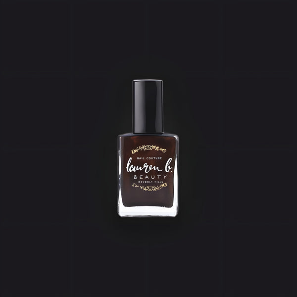 Lauren B. Beauty Espresso On 3rd nail polish bottle in a sleek glass vessel, displayed against a minimalist travertine base.