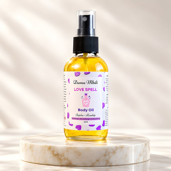 Adorn Collective Love Spell Body Oil in a minimalist amber glass bottle placed on a textured travertine surface.