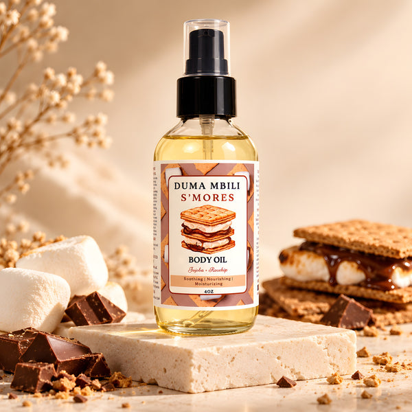 Adorn Collective S'mores Body Oil by Duma Mbili LLC presented in a clear glass bottle against a warm travertine plinth.