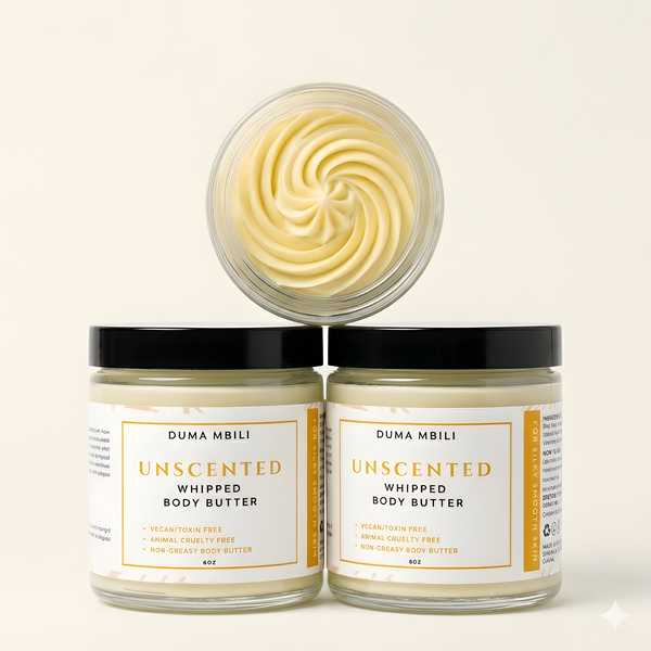 Adorn Collective Unscented Whipped Body Butter in a minimalist glass jar resting on a textured travertine surface.